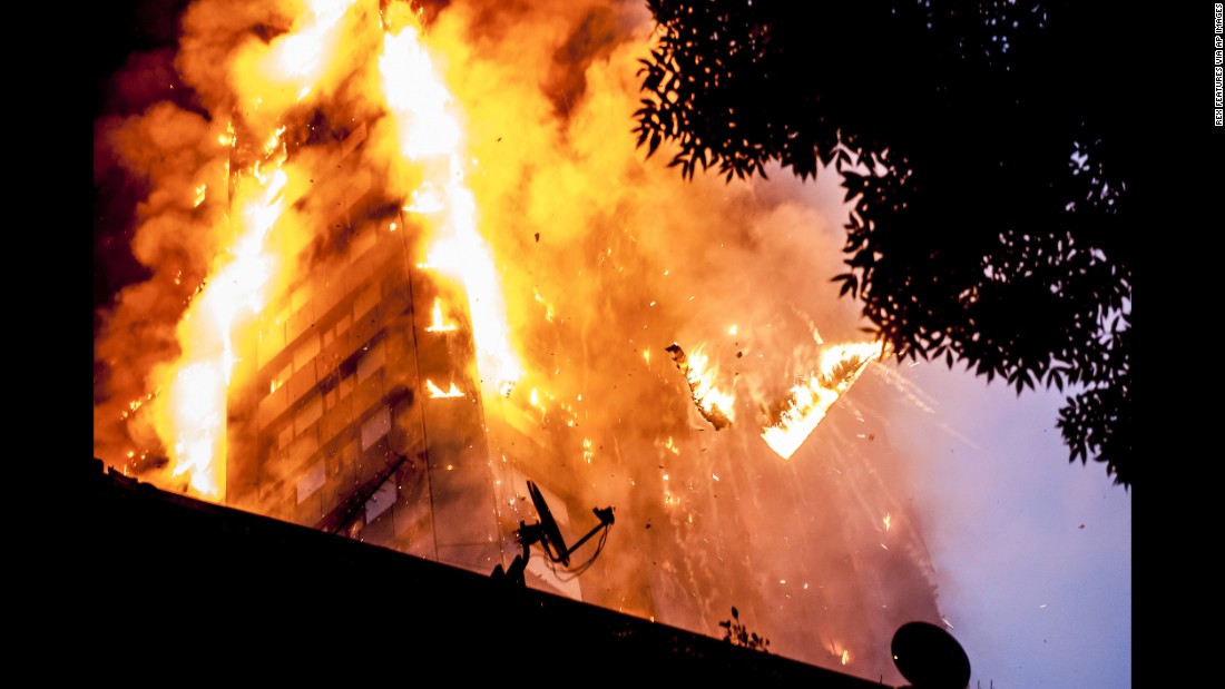 Burning debris falls from Grenfell Tower as a massive fire engulfs the London apartment building early on June 14, 2017. Seventy-two people are confirmed to have died in the fire.