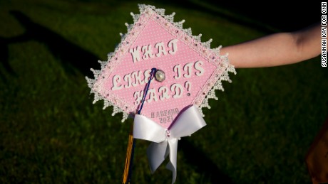 Grace Bannister shows off her graduation cap in her backyard in Chapmanville, West Virginia. Bannister graduated this year as valedictorian of her class and plans to attend Harvard University in the fall. 