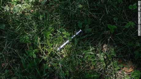 A discarded heroin needle lays in McPherson Square Park, next to the library.