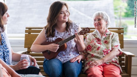 Emma Pino plays the ukulele next to her grandmother, Helen Romage, on her front porch in Mount Hope, West Virginia. Pino plans to attend West Virginia University in the fall, but says she&#39;ll likely leave the state after college. &quot;I will probably always have family ties here so it will be hard to let all that go, but I think I need to.&quot; 