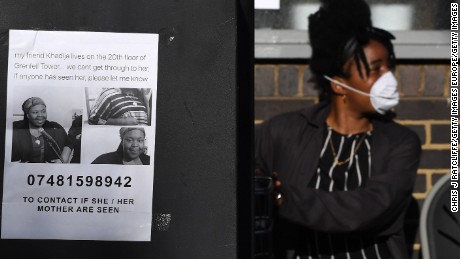 A missing person poster for artist Khadija Saye is posted near the site of a massive residential highrise fire.