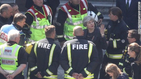 British  Prime Minister Theresa May speaks to firefighters Thursday as she visits Grenfell Tower.