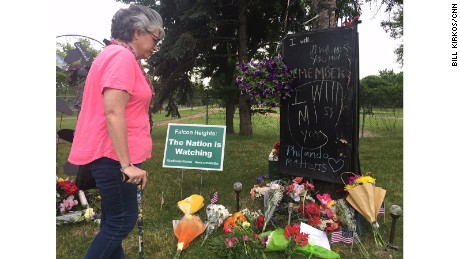 Theresa St. Aoro visits the memorial to place flowers at the site where Philando Castile was shot.