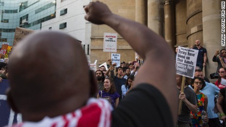 A protester leads a chant, &quot;Justice for Grenfell!&quot; outside the BBC headquarters in central London.