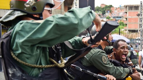 TOPSHOT - Venezuelean National Guard clashes with citizens protesting against the severe food and medicine shortages, in Caracas, Venezuela, on June 8, 2016. / AFP / RONALDO SCHEMIDT        (Photo credit should read RONALDO SCHEMIDT/AFP/Getty Images)