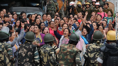 Indian police personnel stop Gorkha Janmukti Morcha (GJM) supporters following a raid at the GJM office in Darjeeling on June 15, 2017.
