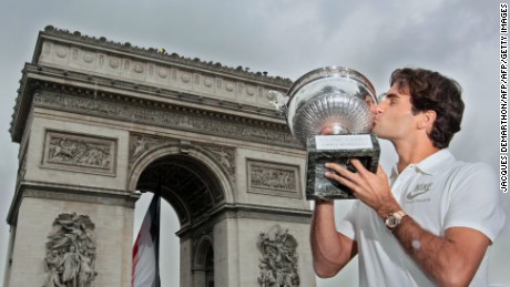 Roger Federer kisses the French Open trophy, having beaten Sweden&#39;s Robin Söderling (6-1, 7-6, 6-4) to complete the career grand slam.