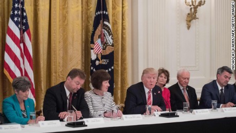 President Trump with, from left, US Sens. Joni Ernst of Iowa, Dean Heller of Nevada, Susan Collins of Maine, Lisa Murkowski of Alaska,  Orrin Hatch of Utah  and Cory Gardner of Colorado as Republican senators meet with Trump to discuss the health care bill.