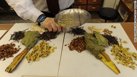 Workers at a traditional chinese medicine store prepare various dried items at a shop in Hong Kong.