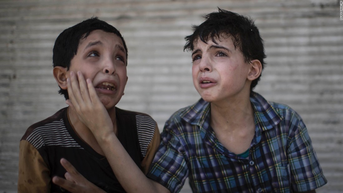 Two boys comfort each other after their home collapsed during fighting between Iraqi forces and militants in Mosul on Saturday, June 24. The boys, who are cousins, said some of their relatives were still under the rubble.