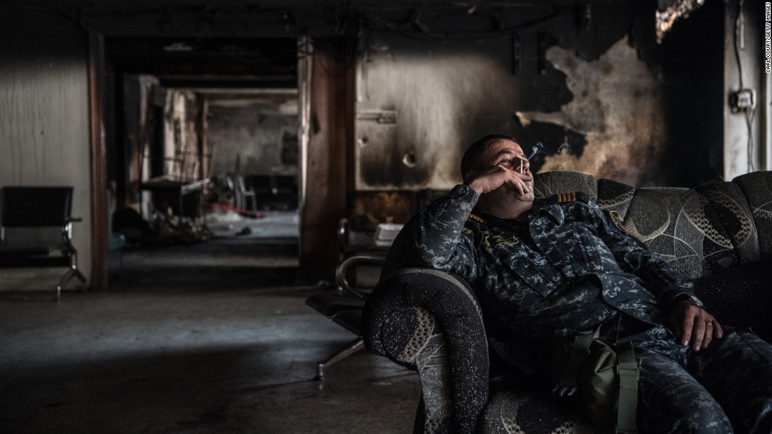 An Iraqi federal policeman smokes during a break from battle on Wednesday, April 12.