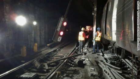 Workers respond to the scene of a subway derailment, Tuesday, June 27, 2017, in Harlem.