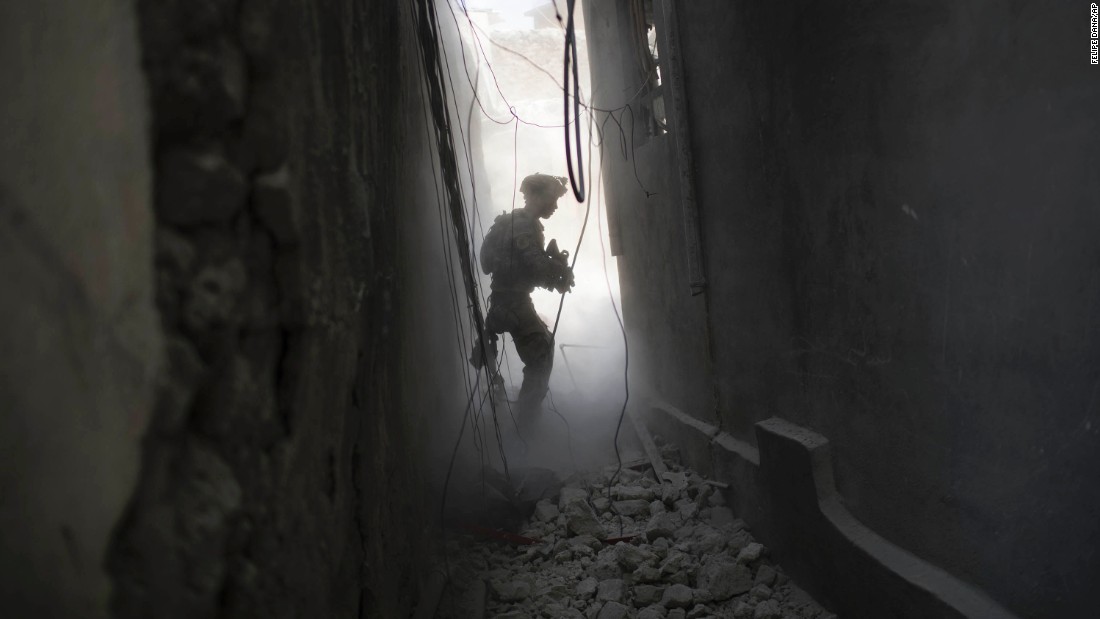 An Iraqi Special Forces soldier exchanges fire with ISIS militants in the Old City on Friday, June 30.