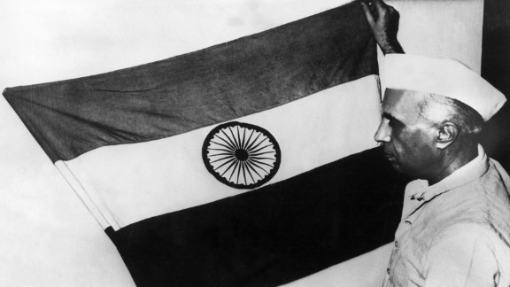 Nehru, then-vice president of the Indian National Congress party, presents the national flag of the nation during a meeting of the constituent assembly in July 1947.