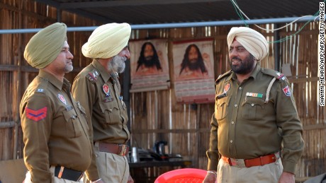 Indian Punjabi police officials stand at a check post near the ashram of Ashutosh Maharaj, some 30 kms from Jalandhar.  
