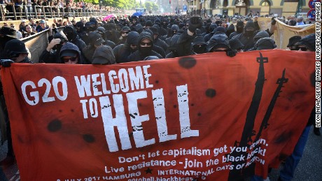 HAMBURG, GERMANY - JULY 06:  Protesters  dressed in all black hold up a banner as they take part in the &quot;Welcome to Hell&quot; protest march on July 6, 2017 in Hamburg, Germany.  Leaders of the G20 group of nations are arriving in Hamburg today for the July 7-8 economic summit and authorities are bracing for large-scale and disruptive protest efforts tonight at the &quot;Welcome to Hell&quot; anti-G20 protest.  (Photo by Leon Neal/Getty Images)