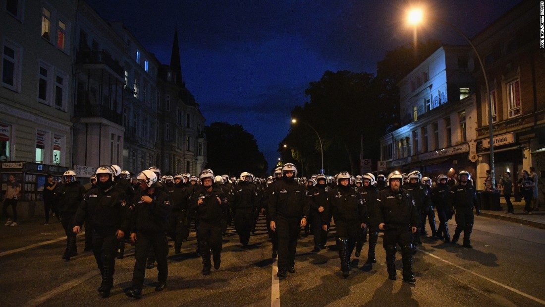 Riot police head down a road during the &quot;Welcome to Hell&quot; protest march on Thursday, July 6. 