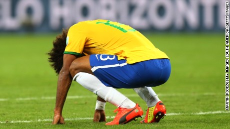 BELO HORIZONTE, BRAZIL - JULY 08:  A dejected Dante  of Brazil reacts after being defeated by Germany 7-1 during the 2014 FIFA World Cup Brazil Semi Final match between Brazil and Germany at Estadio Mineirao on July 8, 2014 in Belo Horizonte, Brazil.  (Photo by Martin Rose/Getty Images)