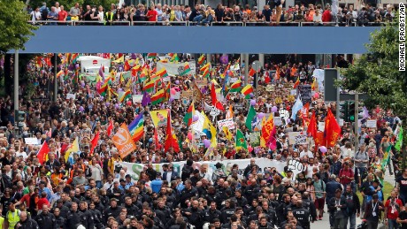 Police escort a protest rally Saturday in Hamburg during the G20 summit.