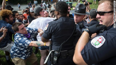 Officers clash with counter protestors who turned out in reaction to a KKK rally.