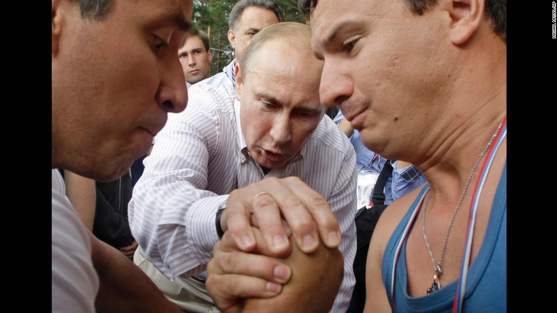 Putin officiates an arm-wrestling contest as he visits a youth educational forum near Russia&#39;s Lake Seliger in August 2011.