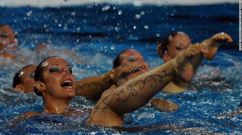 Members of the Hungarian synchronized swimming team perform during the halftime break of the Water Polo European Championships match Hungary vs Spain  in Budapest on July 14, 2014.