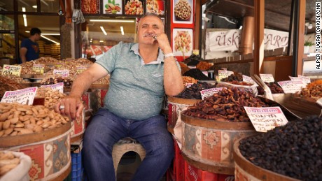 Hasan Dervisoglyu sits outside his spice and nuts stop near the Ankara castle.
