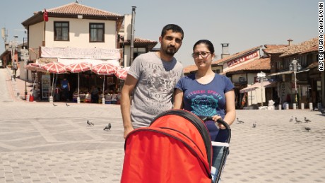 Volkan Guner with his partner Merve, also 27, and their three-month child.