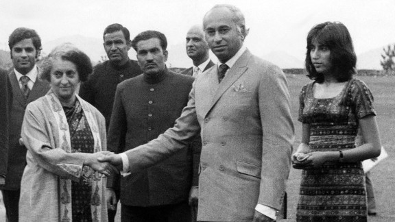 Then-Pakistani President Zulfikar Ali Bhutto (center) shakes hands with then-Indian Prime Minister Indira Gandhi (left). Gandhi succeeded her late father, Nehru, who passed away on May 27, 1964. Bhutto