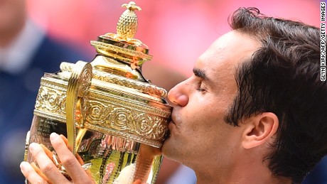 Switzerland&#39;s Roger Federer kisses the winner&#39;s trophy after beating Croatia&#39;s Marin Cilic in their men&#39;s singles final match, during the presentation on the last day of the 2017 Wimbledon Championships at The All England Lawn Tennis Club in Wimbledon, southwest London, on July 16, 2017. Federer won 6-3, 6-1, 6-4.