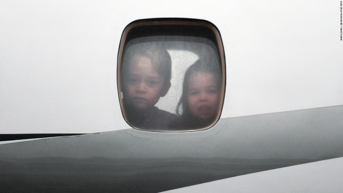 Prince George and Princess Charlotte peer through the window of the plane as they arrive on July 17, in Warsaw, Poland.