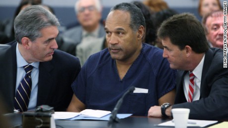 O.J. Simpson, center, appears in court with attorneys Gabriel Grasso, left, and Yale Galanter before sentencing at the Clark County Regional Justice Center on December 5, 2008, in Las Vegas.