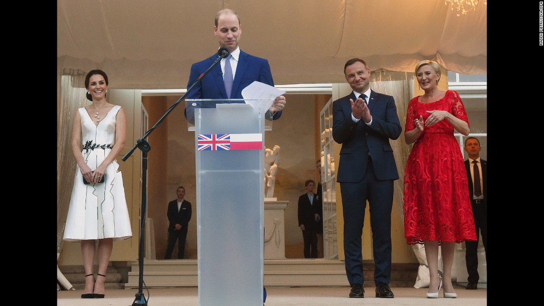 William speaks as Kate, left, and Polish President Andrzej Duda and his wife, Agata Kornhauser-Duda, listen during a Queen&#39;s birthday party on July 17, in the Orangery in Lazienki Park in Warsaw, Poland.