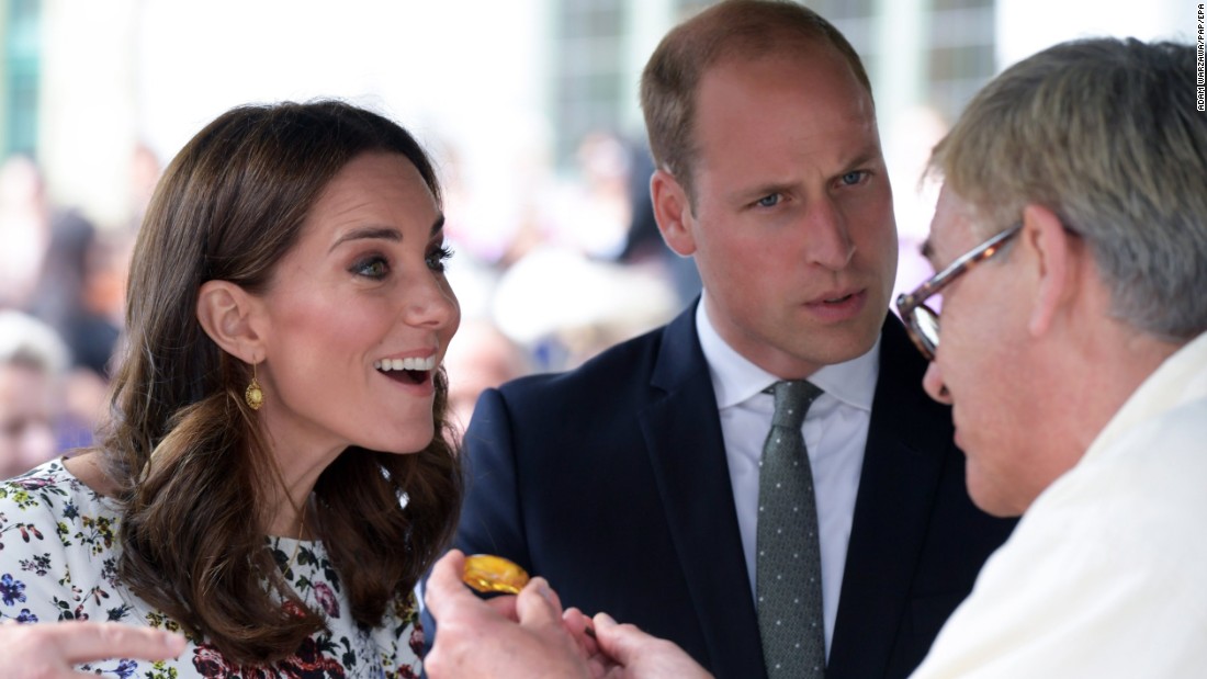 Kate and William are shown a piece of amber by a local craftsman during a visit on July 18, to the Gdansk central market in Poland.