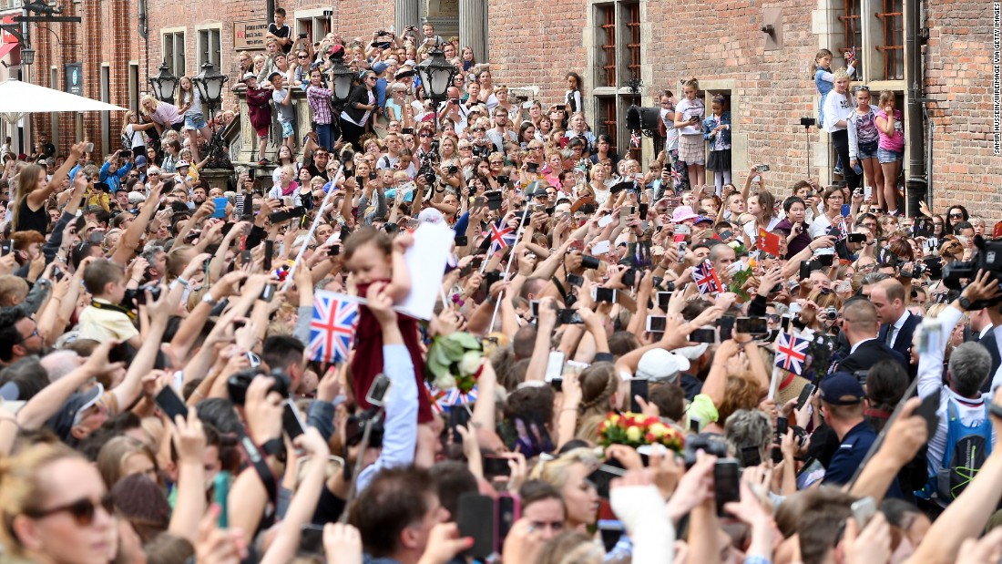 A crowd lines the street to greet the royal couple during their visit to Gdansk, Poland.
