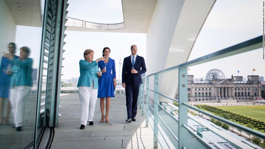 German Chancellor Angela Merkel shows William and Kate a view from the Federal Chancellery on July 19, in Berlin, in this In this handout photo from the German government&#39;s press office.