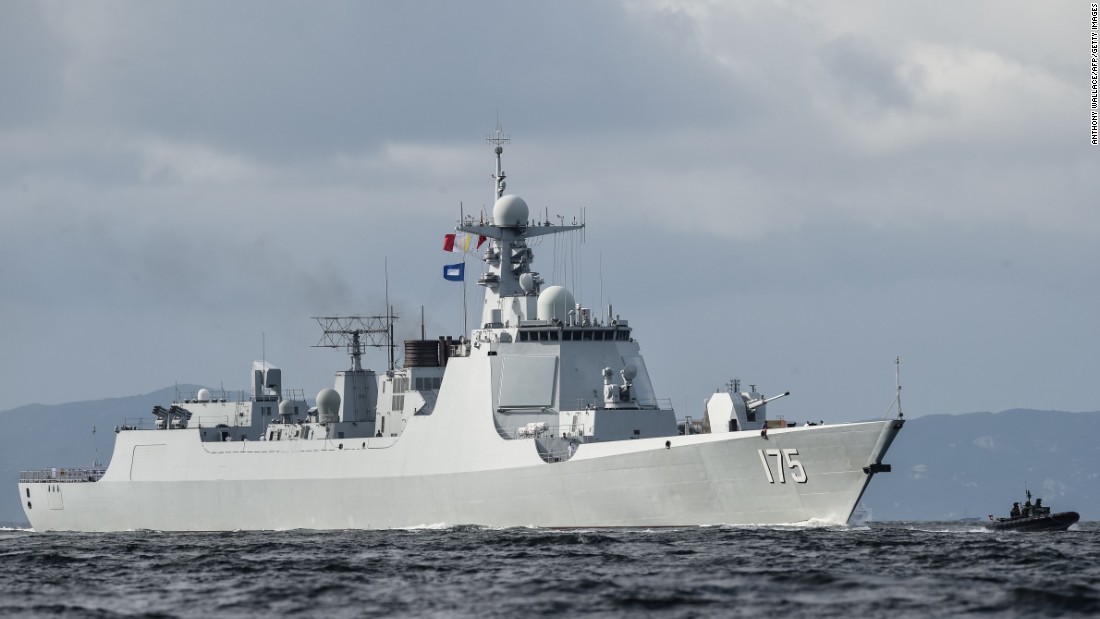 A Type 052D destroyer of China&#39;s People&#39;s Liberation Army Navy provides an escort ahead of the Liaoning aircraft carrier into the Lamma Channel as it arrives in Hong Kong territorial waters on July 7, 2017.