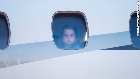 Princess Charlotte peers out of the airplane window upon the arrival at the airport in Berlin on Wednesday.