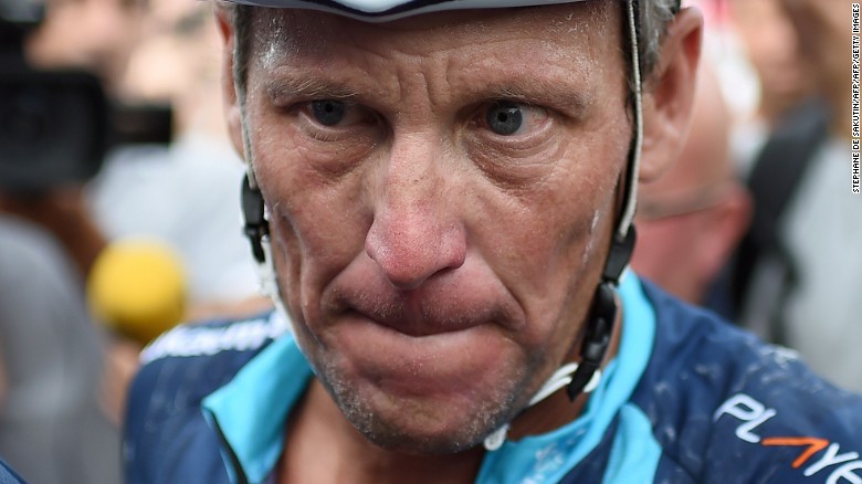 US cyclist Lance Armstrong looks on upon his arrival in Rodez, southwest France, after riding a stage  of The Tour De France for a leukaemia charity, a day ahead of the competing riders, on July 16, 2015. 