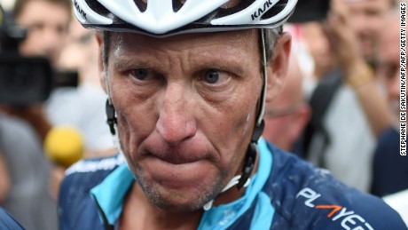 US cyclist Lance Armstrong looks on upon his arrival in Rodez, southwest France, after riding a stage  of The Tour De France for a leukaemia charity, a day ahead of the competing riders, on July 16, 2015. For the first time since he was stripped of his seven Tour de France titles, disgraced cyclist Lance Armstrong rode a stage of the famous race for charity. Armstrong, 43, was riding a 198-kilometre (123-mile) stage a day ahead of the competing riders for a leukaemia charity but cycling officials have branded the exercise &quot;disrespectful&quot;. AFP PHOTO / STEPHANE DE SAKUTIN        (Photo credit should read STEPHANE DE SAKUTIN/AFP/Getty Images)
