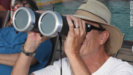 Bill Kramer observing a total solar eclipse through solar filtered binoculars while in Indonesia in 2016.