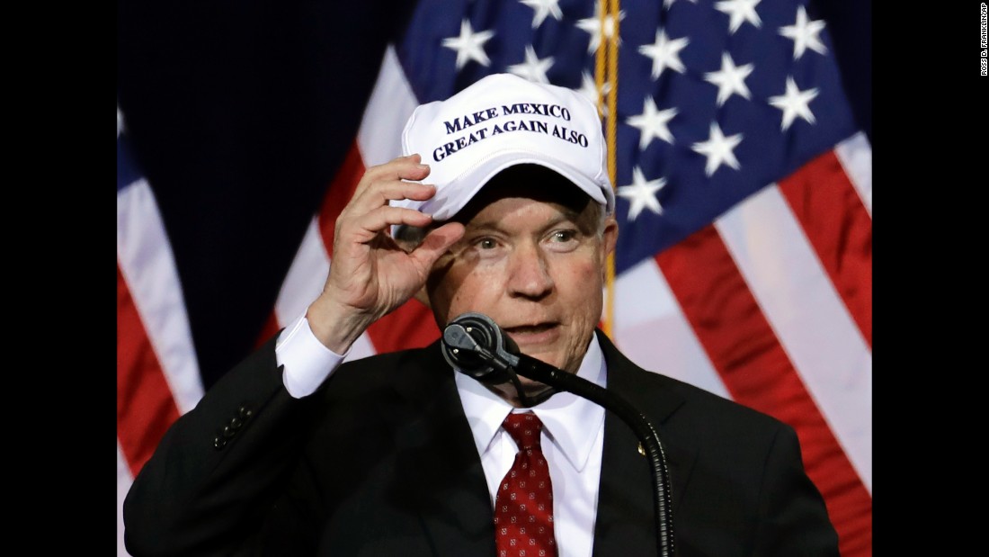 Sessions wears a &quot;Make Mexico Great Again Also&quot; hat before a Trump speech during a campaign rally at the Phoenix Convention Center in August  2016.