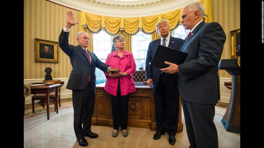 Vice President Mike Pence swears in Sessions as attorney general while Sessions&#39; wife and President Trump look on in the Oval Office on February 9, 2017. Sessions was approved after a contentious battle along party lines.