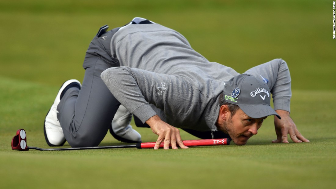 Wales&#39; Stuart Manley lines up a putt on the eighth green during his opening round. Wet, cool and breezy conditions, as well as enthusiastic crowds, greeted the first group of players to go out at 6:35 a.m.