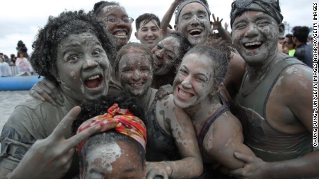 BORYEONG, SOUTH KOREA - JULY 16:  Festival-goers enjoy the mud during the annual Boryeong Mud Festival at Daecheon Beach on July 16, 2016 in Boryeong, South Korea. The mud, which is believed to have benefical effects on the skin due to its mineral content, is sourced from mud flats near Boryeong and transported to the beach by truck.  (Photo by Chung Sung-Jun/Getty Images)