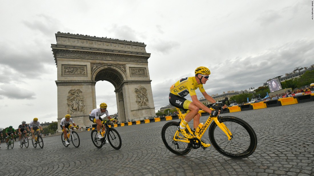 Against the backdrop of the Arc de Triomphe, Britain&#39;s Chris Froome rides to his fourth Tour de France win.