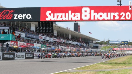Riders rush towards thier motorbikes at the start of the 2016 Suzuka 8 Hours race.