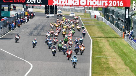Riders stream away from the pit straight at the start of the 2016 Suzuka 8 Hours race.