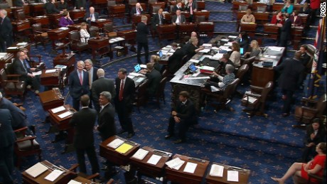 Senators talk on the floor of the US Senate before the vote on the &quot;skinny repeal&quot; on July 28.