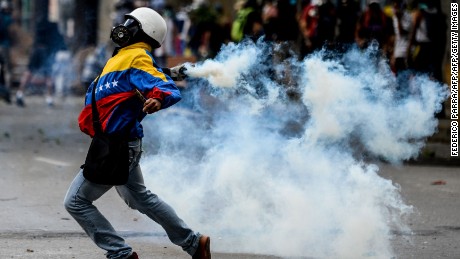 Opposition demonstrators clash with riot police ensuing an anti-government protest in Caracas, on July 26, 2017.
Venezuelans blocked off deserted streets Wednesday as a 48-hour opposition-led general strike aimed at thwarting embattled President Nicolas Maduro's controversial plans to rewrite the country's constitution got underway. / AFP PHOTO / FEDERICO PARRA        (Photo credit should read FEDERICO PARRA/AFP/Getty Images)